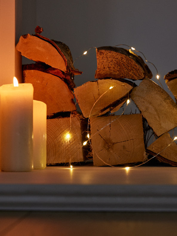 copper string lights on logs