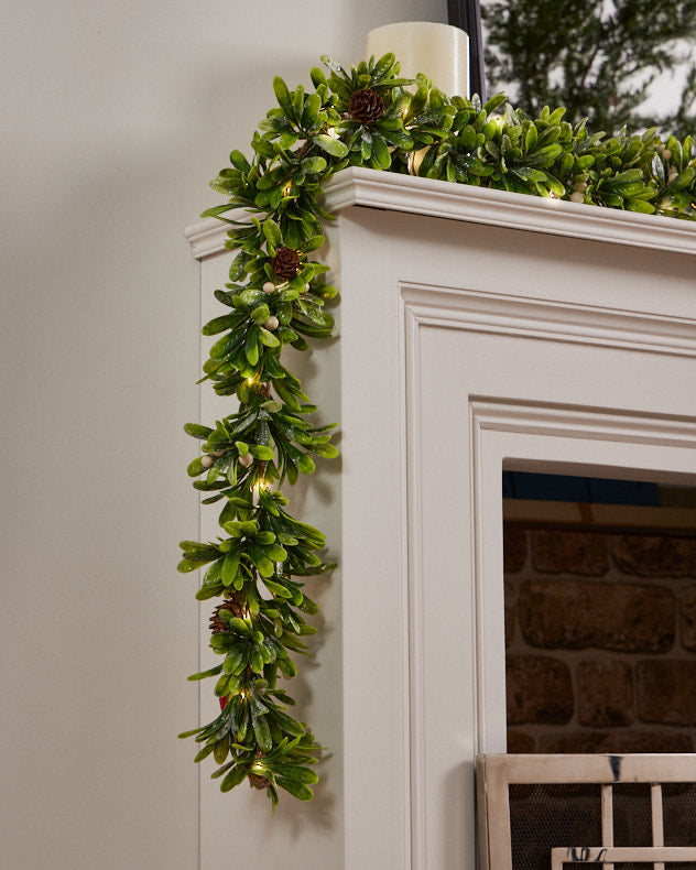 green glitter christmas garland on mantle
