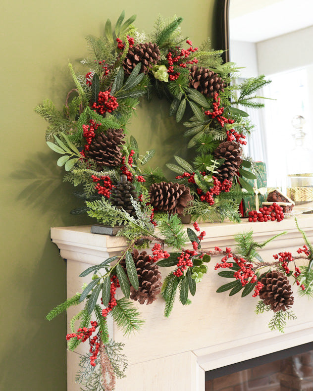 christmas red and green wreath and garland on fireplace