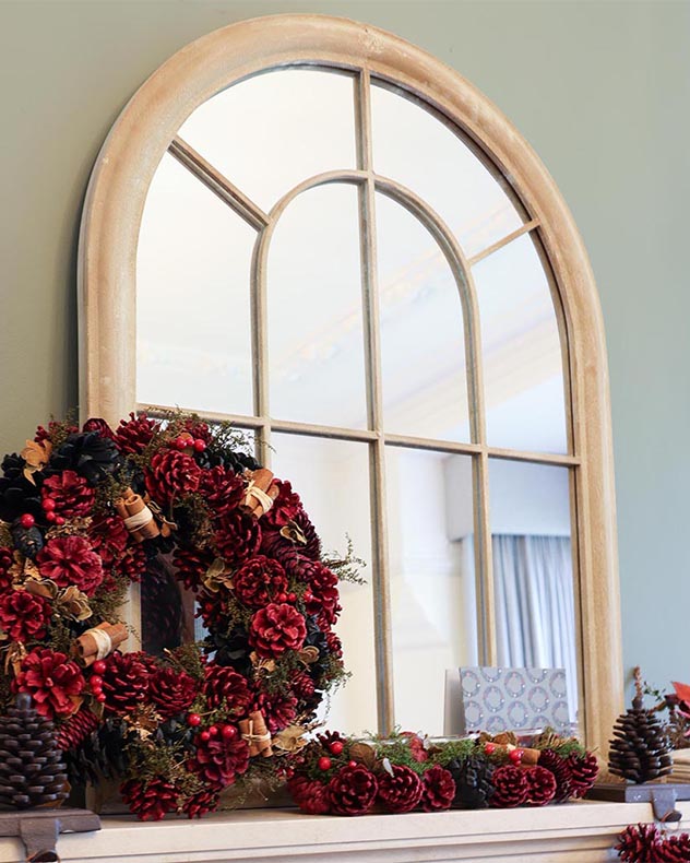 arch window mirror above fireplace