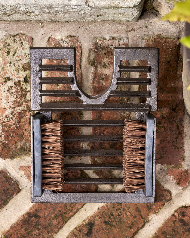 Cast iron boot jack and outlet scraper