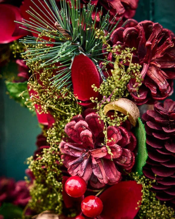 Red berries and pinecones on wreath