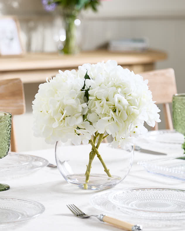 White Hydrangeas in Glass Globe Vase