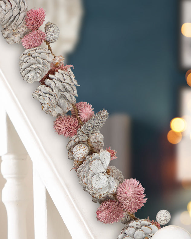 pink and white christmas garland on banister