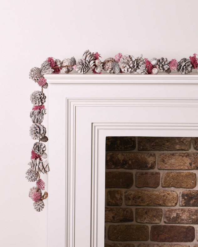 pink and white pinecone garland on mantle