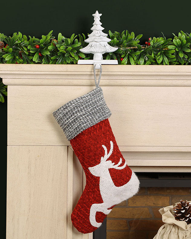 christmas stocking and green garland on mantle