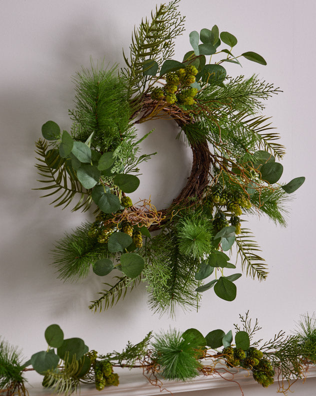 matching green wreath and garland on mantle