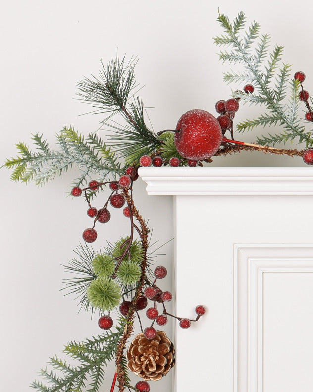 red berry and apple garland on mantle