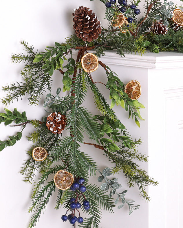 christmas pinecone and orange garland on mantle