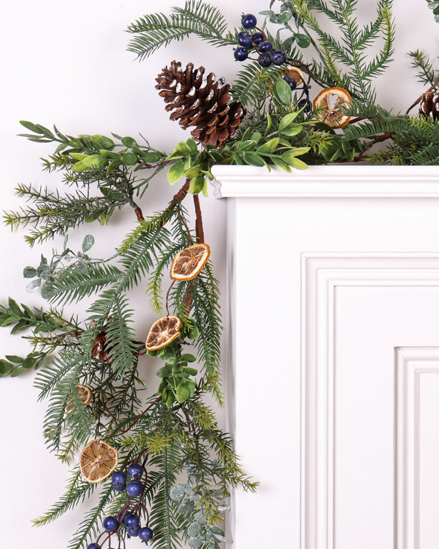 christmas pinecone and orange garland on mantle