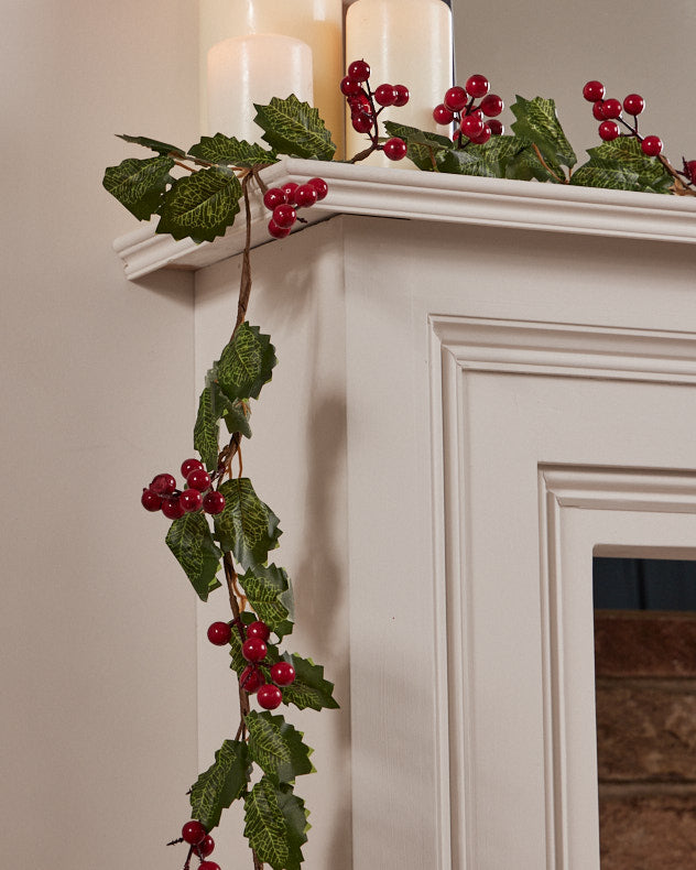 red berry christmas garland on mantle