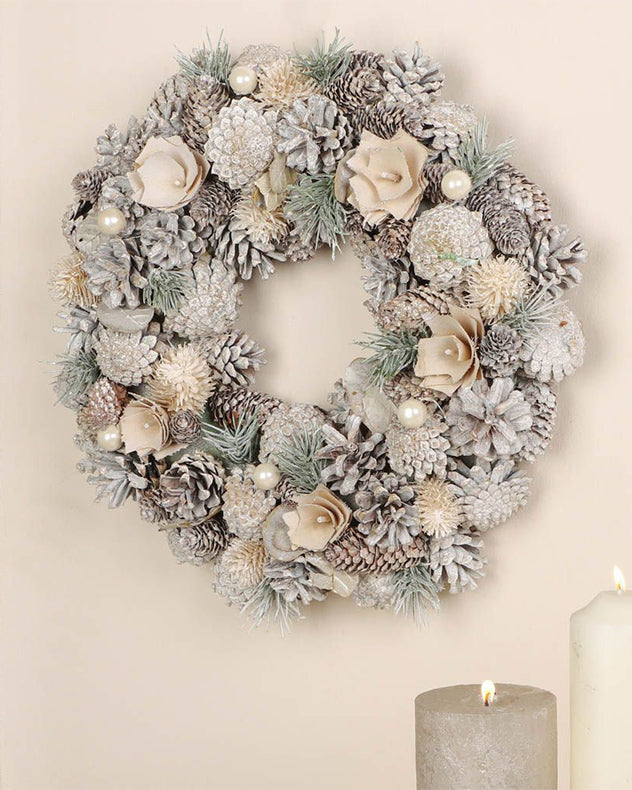 Couronne de fleurs givrées et de pommes de pin d'intérieur