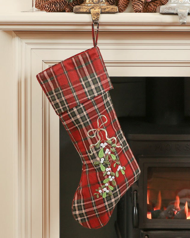 tartan christmas stocking hanging from mantle